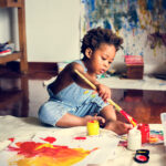 child painting indoors