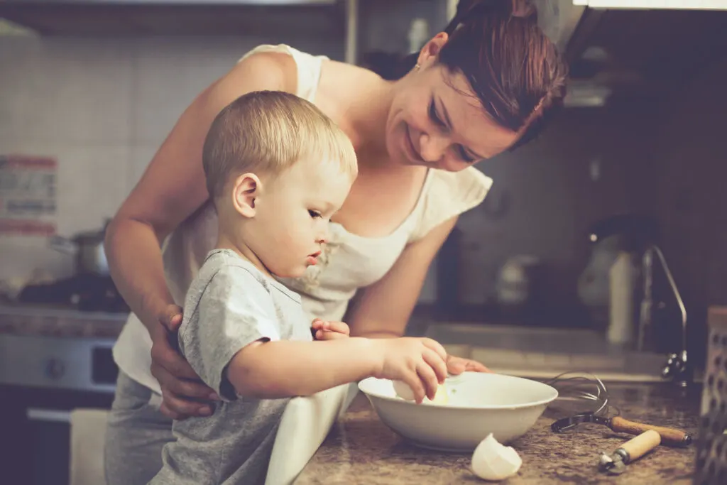 image of child cooking with mother as a morning activity.