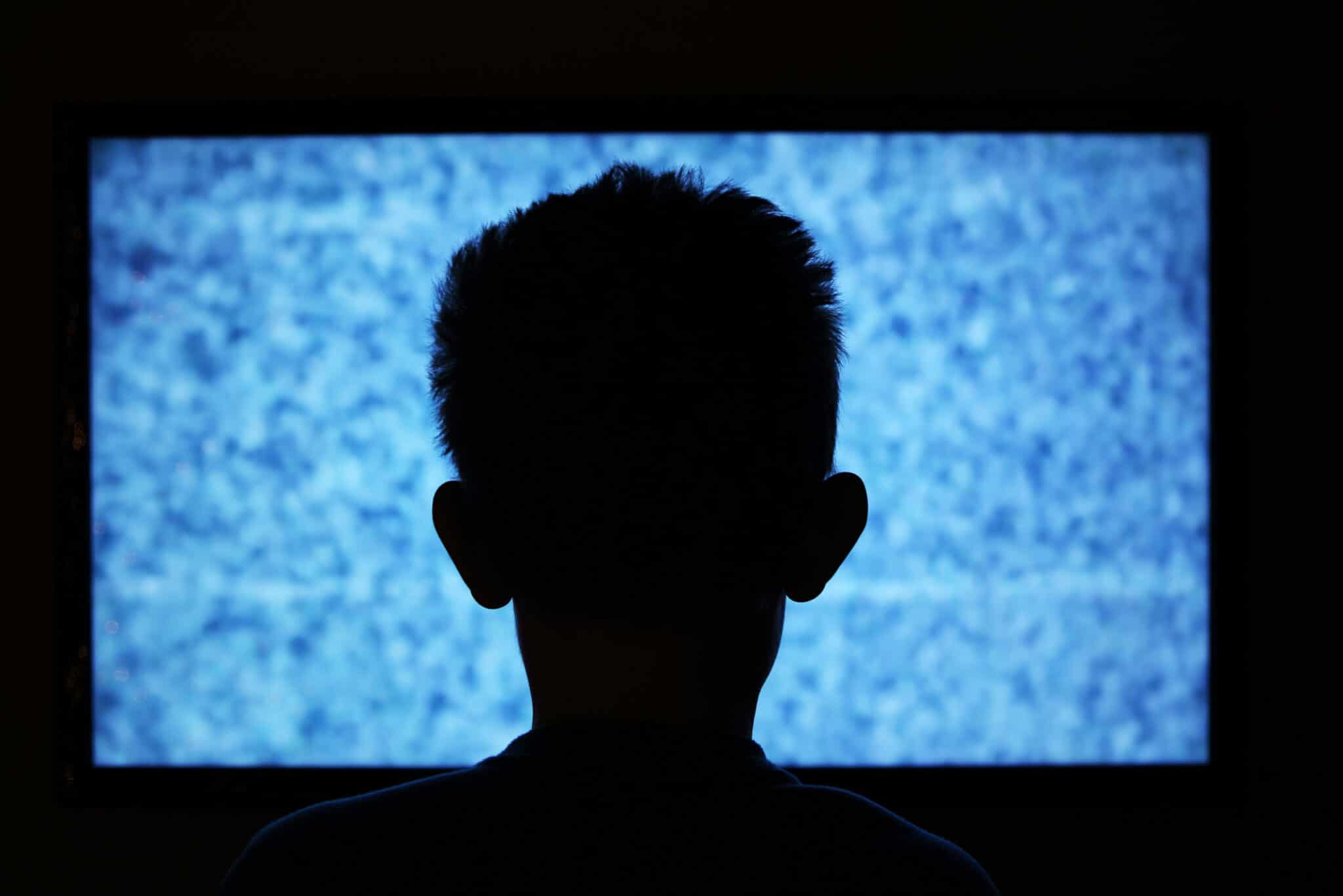 virtual autism header image. child watching static on tv.