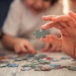 image of adult doing screnn free activities of puzzles.