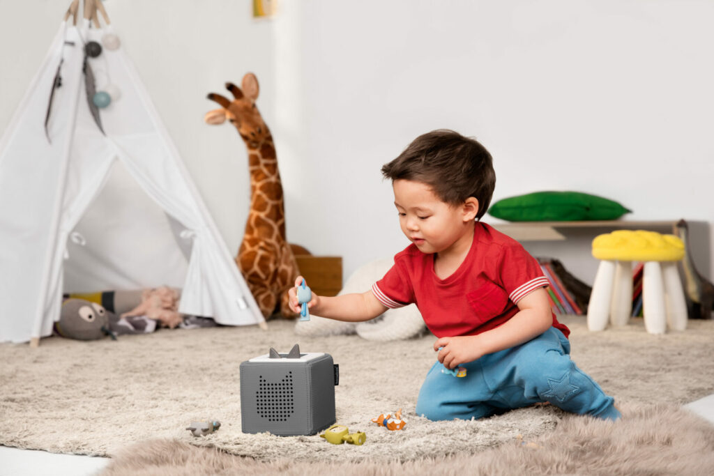 image of child playing with toniebox.