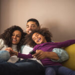 Image of family enjoying movie together, showing on of the 10 reasons why screen time is good.