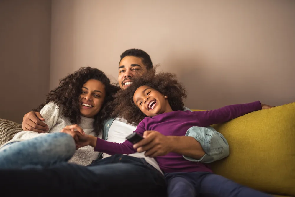 Image of family enjoying movie together, showing on of the 10 reasons why screen time is good.