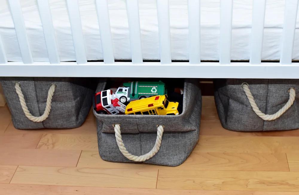 Image of nursing basket underneath crib.